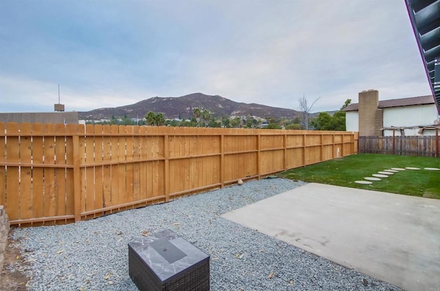 view of yard with a mountain view and a patio area