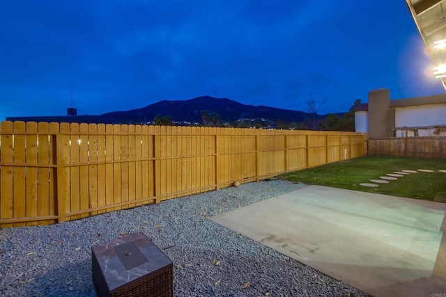 view of yard with a mountain view and a patio area