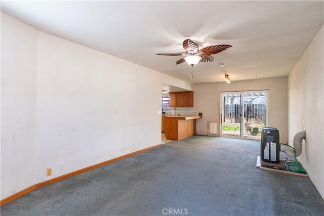 unfurnished living room with carpet and ceiling fan