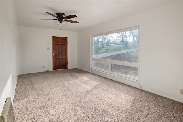 unfurnished room featuring ceiling fan and carpet flooring