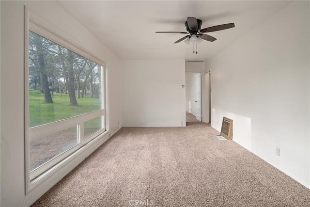 spare room featuring ceiling fan and carpet