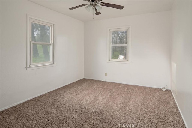 empty room with ceiling fan and carpet flooring