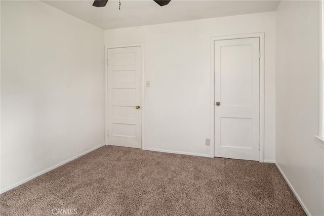 carpeted empty room featuring ceiling fan