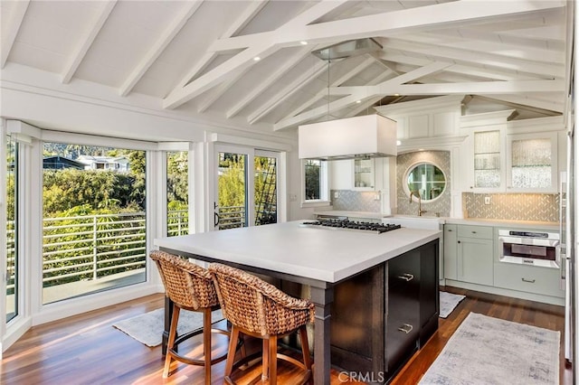 interior space featuring vaulted ceiling with beams and a sink