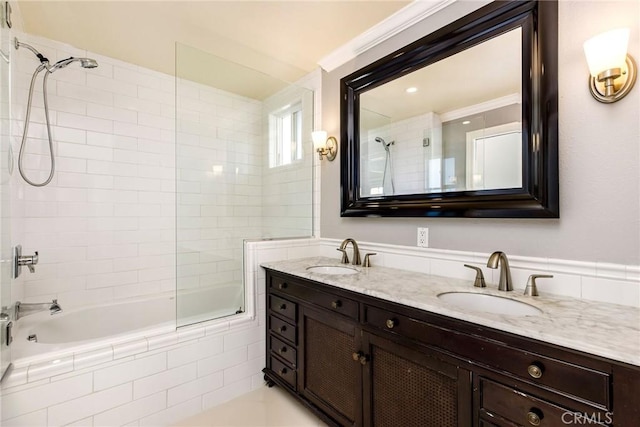 full bath featuring double vanity, tiled shower / bath, and a sink