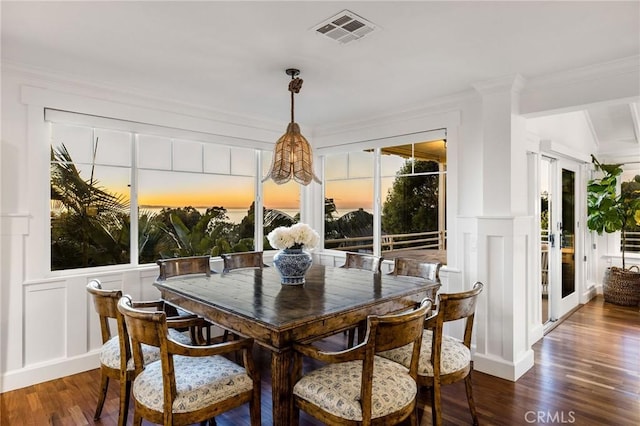 31777 5th Ave, Laguna Beach, CA 92651 - dining room with a decorative wall, dark wood-style flooring, crown molding, a wainscoted wall, and decorative columns