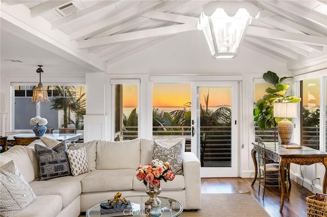 sunroom featuring a chandelier, visible vents, and lofted ceiling with beams