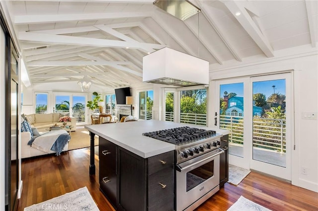 kitchen with high end stove, open floor plan, and vaulted ceiling with beams