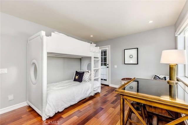 bedroom with baseboards, recessed lighting, and wood finished floors