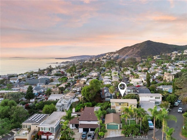 drone / aerial view with a residential view and a water and mountain view