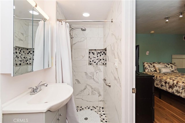 bathroom with vanity, curtained shower, and wood-type flooring