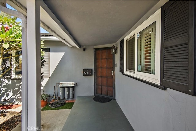 view of exterior entry with covered porch