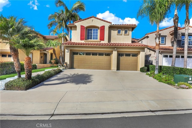 mediterranean / spanish-style home featuring a garage