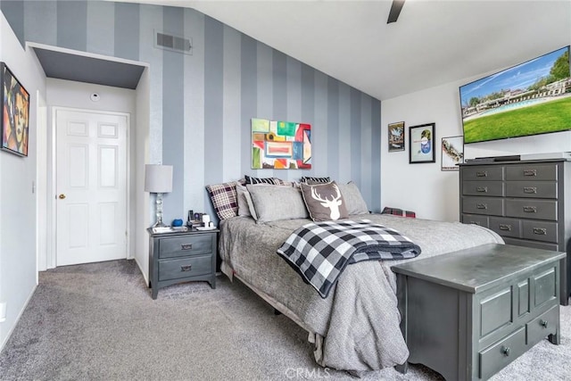 carpeted bedroom with vaulted ceiling and ceiling fan