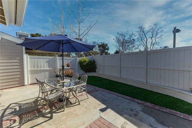 view of patio featuring a fenced backyard and outdoor dining space