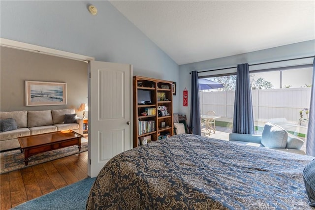 bedroom featuring lofted ceiling and wood finished floors