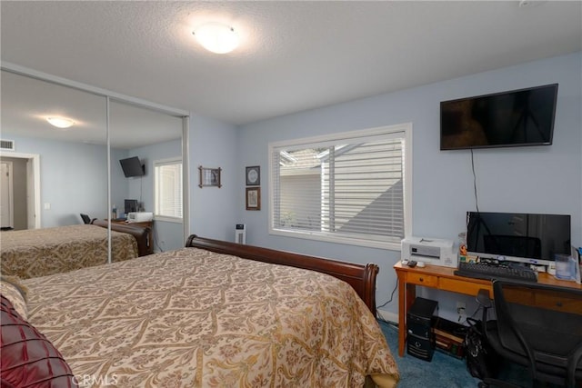 carpeted bedroom with a closet and visible vents