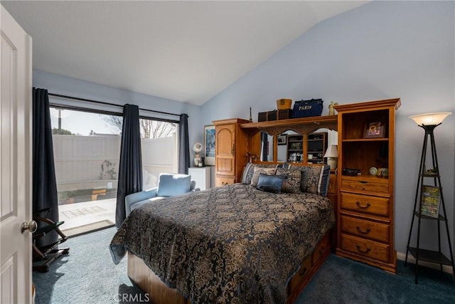 bedroom with lofted ceiling and dark carpet