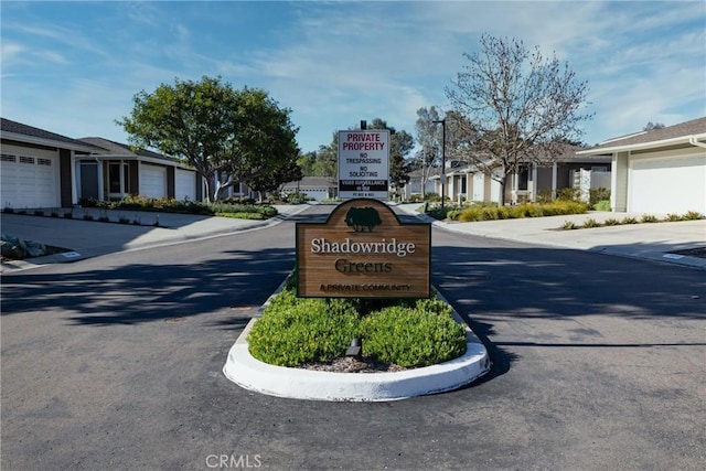 view of road with a residential view and curbs