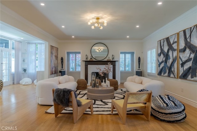 sitting room featuring ornamental molding, a fireplace, and light wood-type flooring