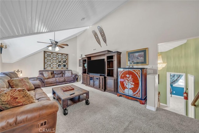 living area with ceiling fan, carpet floors, high vaulted ceiling, and baseboards