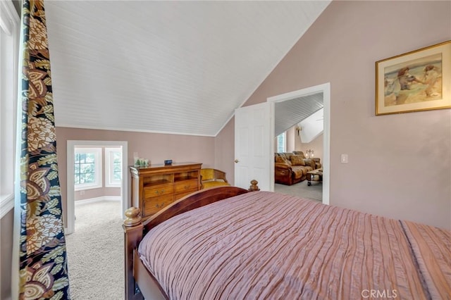 carpeted bedroom with lofted ceiling