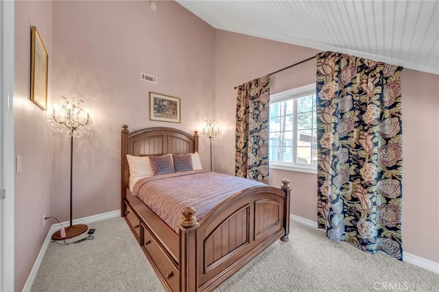 bedroom with lofted ceiling, light colored carpet, and baseboards