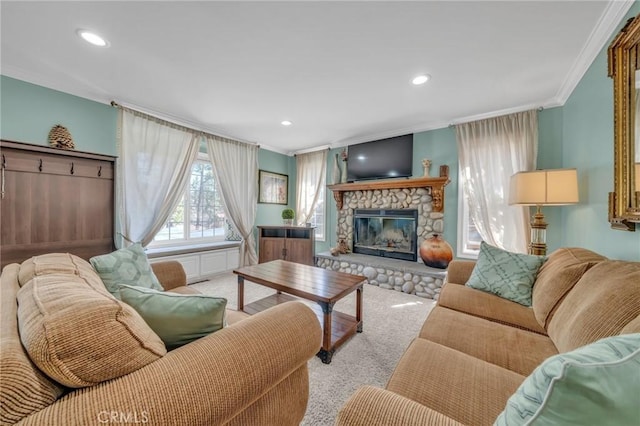 living room featuring recessed lighting, a fireplace, crown molding, and light colored carpet