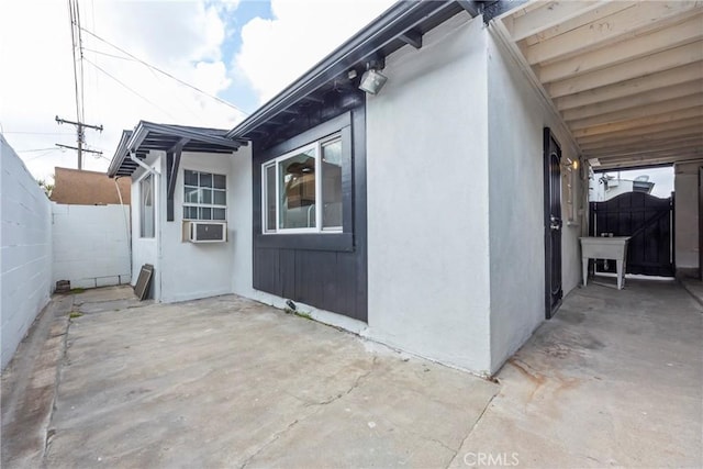 view of side of home featuring cooling unit and a patio area