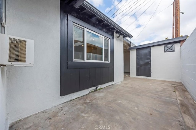 view of side of property with an outbuilding and a patio area