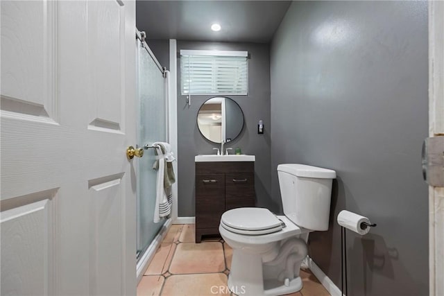 bathroom featuring tile patterned floors, toilet, a shower with shower door, and vanity