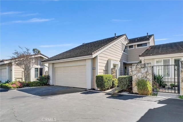 view of property exterior featuring aphalt driveway and an attached garage