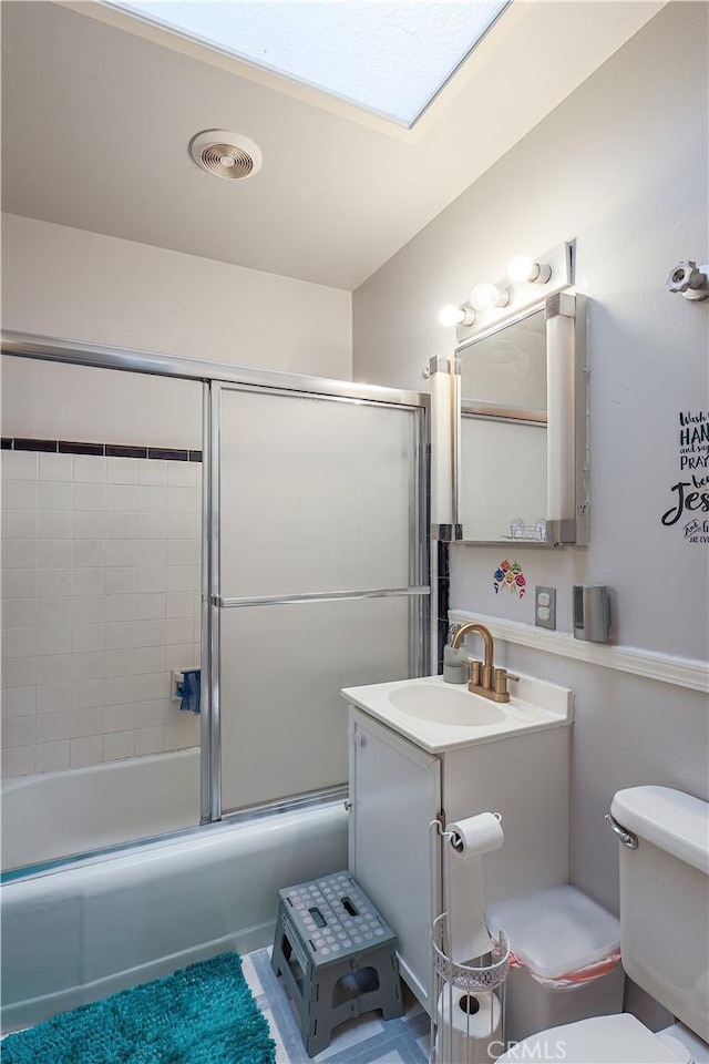 full bathroom with vanity, toilet, and combined bath / shower with glass door