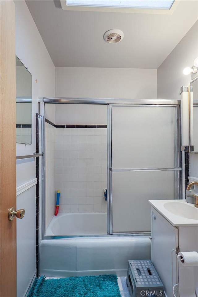 bathroom featuring vanity, tile patterned flooring, and shower / bath combination with glass door