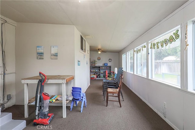 dining area featuring dark carpet