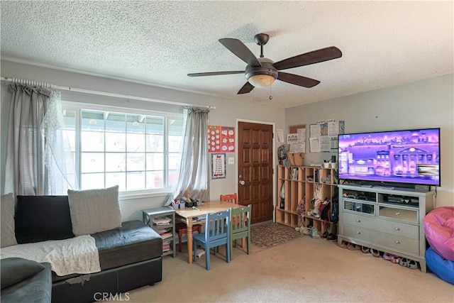 carpeted living room featuring ceiling fan and a textured ceiling