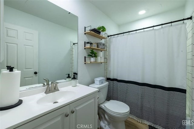 bathroom featuring vanity and toilet