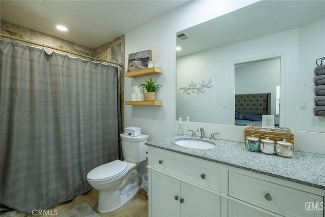 bathroom with a shower with curtain, vanity, toilet, and wood-type flooring