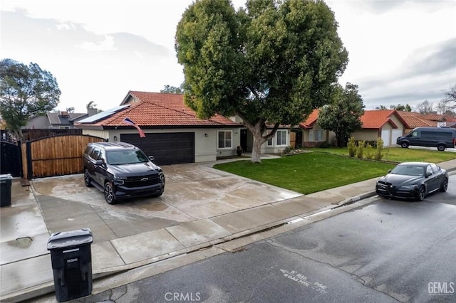 view of front of property featuring a garage and a front lawn