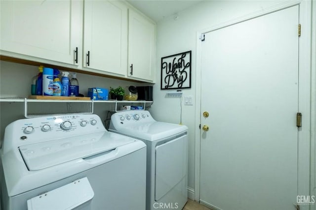 laundry room with independent washer and dryer and cabinets