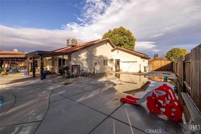 rear view of property with a patio and central air condition unit