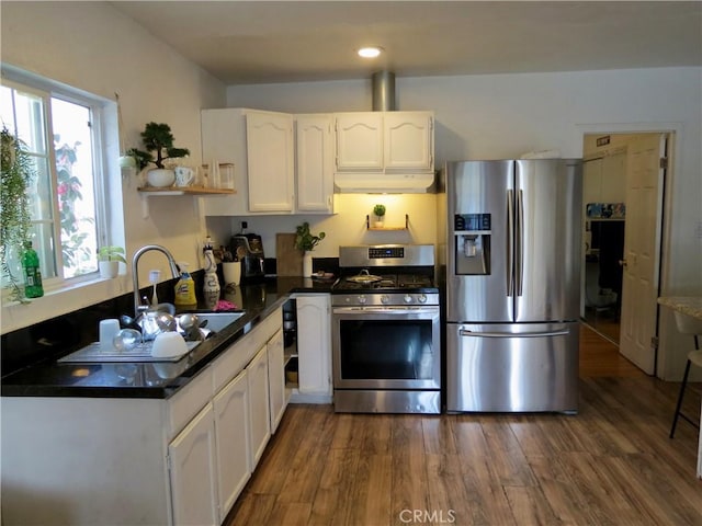 kitchen with sink, dark wood-type flooring, white cabinets, and appliances with stainless steel finishes