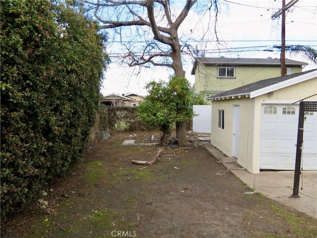 view of yard featuring an outbuilding and a garage