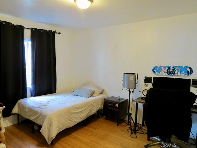 bedroom with light hardwood / wood-style floors