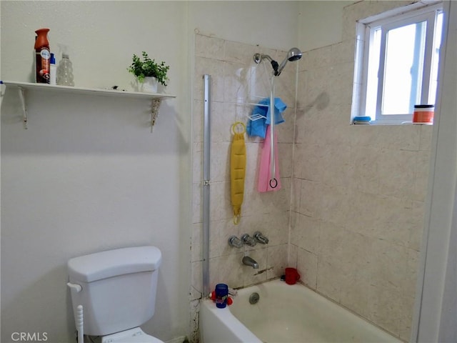 bathroom featuring toilet and tiled shower / bath combo