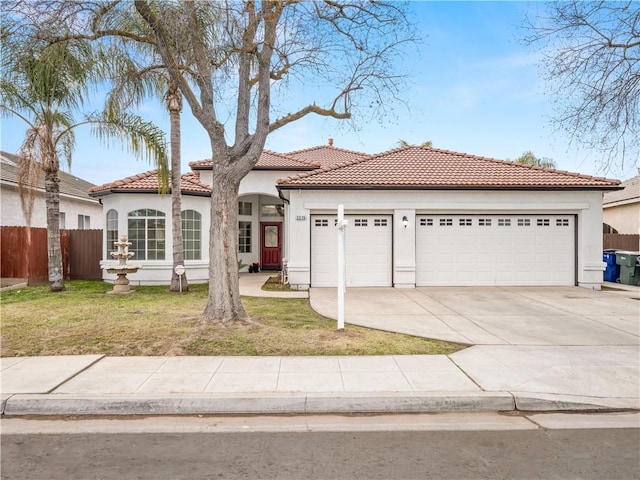 mediterranean / spanish house featuring a garage and a front lawn