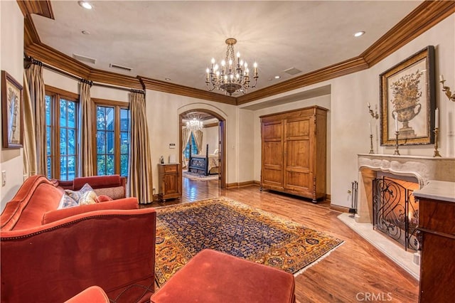 22931 Sonriente Trl, Coto De Caza, CA 92679 - living area with a chandelier, arched walkways, crown molding, wood finished floors, and baseboards