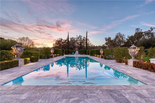 22931 Sonriente Trl, Coto De Caza, CA 92679 - pool at dusk with an outdoor pool and a patio area
