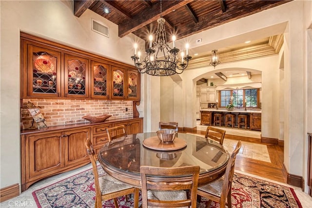 22931 Sonriente Trl, Coto De Caza, CA 92679 - dining space featuring wooden ceiling, arched walkways, light wood-style floors, a chandelier, and baseboards