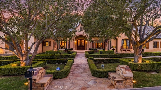 view of front of house with french doors and stucco siding